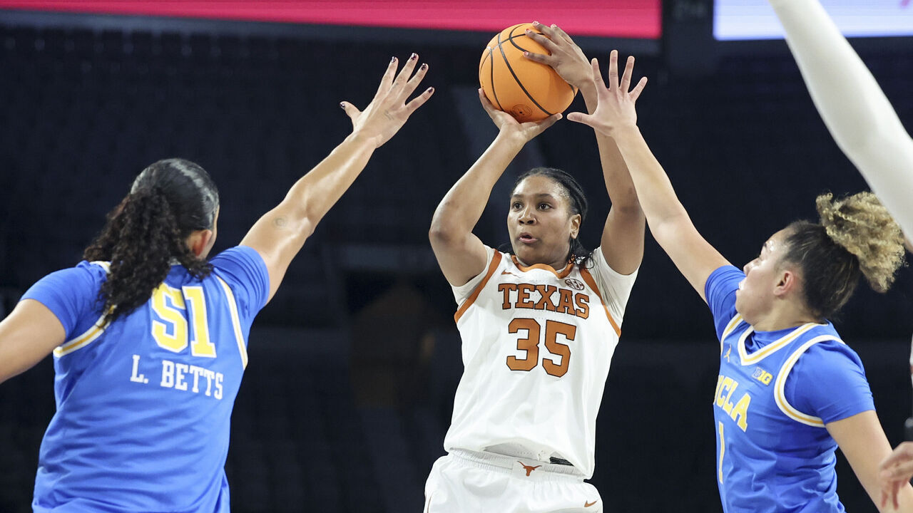 LAS VEGAS, NEVADA - NOVEMBER 26: Madison Booker #35 of the Texas Longhorns shoots against Lauren Betts #51 and Kiki Rice #1 of the UCLA Bruins during the first quarter of a Players Era Championship basketball tournament game at Michelob ULTRA Arena on November 26, 2025 in Las Vegas, Nevada.