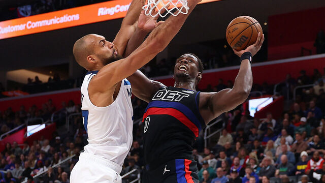 DETROIT, MICHIGAN - APRIL 02: Jalen Duren #0 of the Detroit Pistons drives to the basket past Rudy Gobert #27 of the Minnesota Timberwolves during the first half at Little Caesars Arena on April 02, 2026 in Detroit, Michigan.