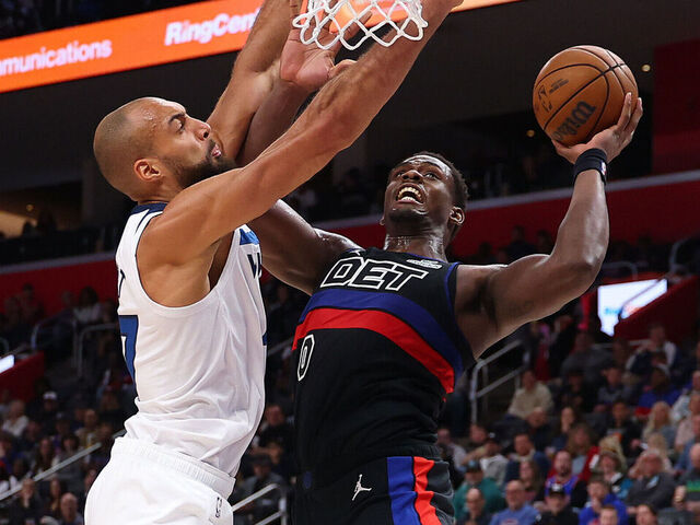 DETROIT, MICHIGAN - APRIL 02: Jalen Duren #0 of the Detroit Pistons drives to the basket past Rudy Gobert #27 of the Minnesota Timberwolves during the first half at Little Caesars Arena on April 02, 2026 in Detroit, Michigan.