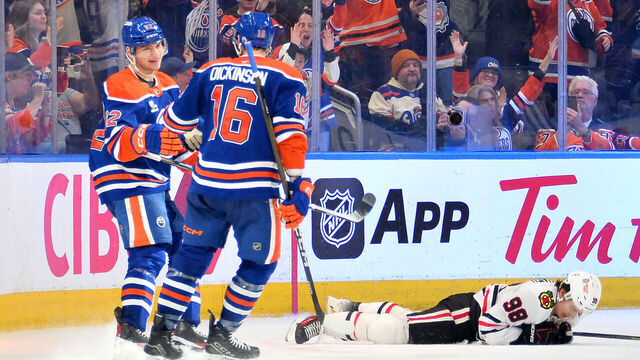 EDMONTON, CANADA - APRIL 2: Connor Bedard #98 of the Chicago Blackhawks reacts on the ice as Vasily Podkolzin #92 and Jason Dickinson #16 of the Edmonton Oilers celebrate an empty-net goal during the third period of the game at Rogers Place on April 2, 2026, in Edmonton, Alberta, Canada.