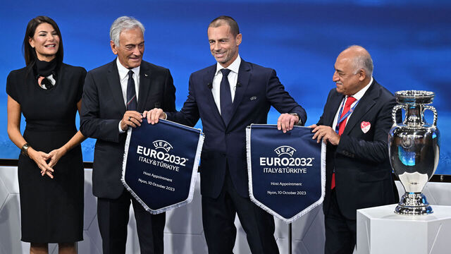 President of the Turkish Football Federation (TFF) Mehmet Buyukeksi (R), Italian TV host and commentator Ilaria D'Amico (L), President of the Italian Football Federation (FIGC) Gabriele Gravina (2ndL) and UEFA president Aleksander Ceferin (C) pose holding pennants after Turkey and Italy were elected to host the Euro 2032 fooball tournament during the announcement ceremony at the UEFA headquarters in Nyon on October 10, 2023.