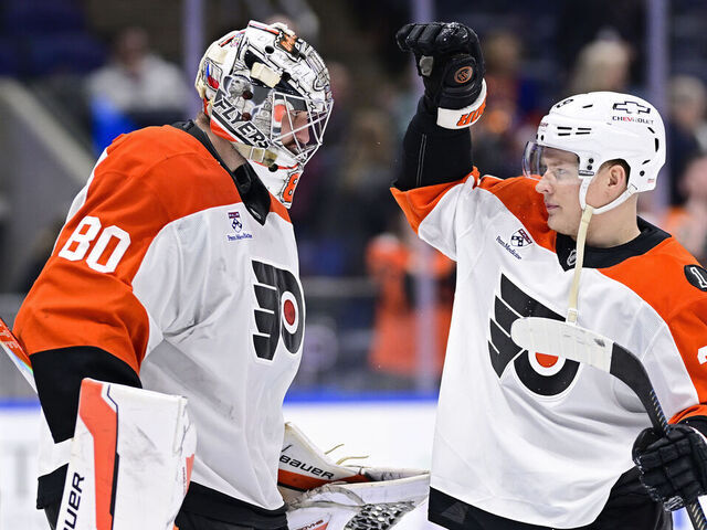 ELMONT, NEW YORK - APRIL 03: Dan Vladar #80 and Matvei Michkov #39 of the Philadelphia Flyers celebrate after defeating the New York Islanders 4-1 at UBS Arena on April 03, 2026 in Elmont, New York.