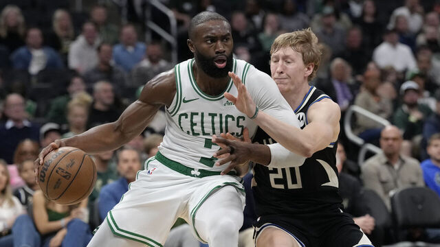 MILWAUKEE, WISCONSIN - APRIL 03: Jaylen Brown #7 of the Boston Celtics dribbles the ball against A.J. Green #20 of the Milwaukee Bucks during the third quarter at Fiserv Forum on April 03, 2026 in Milwaukee, Wisconsin.
