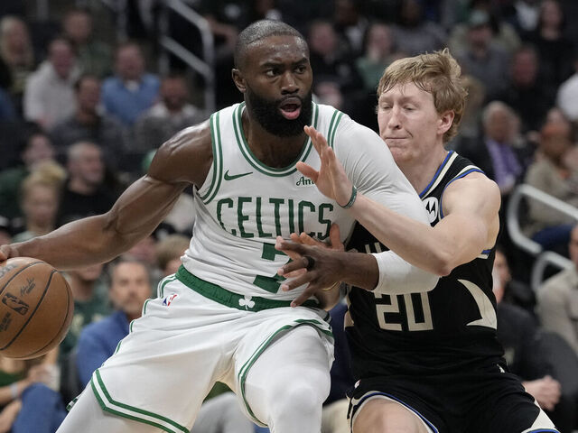 MILWAUKEE, WISCONSIN - APRIL 03: Jaylen Brown #7 of the Boston Celtics dribbles the ball against A.J. Green #20 of the Milwaukee Bucks during the third quarter at Fiserv Forum on April 03, 2026 in Milwaukee, Wisconsin.