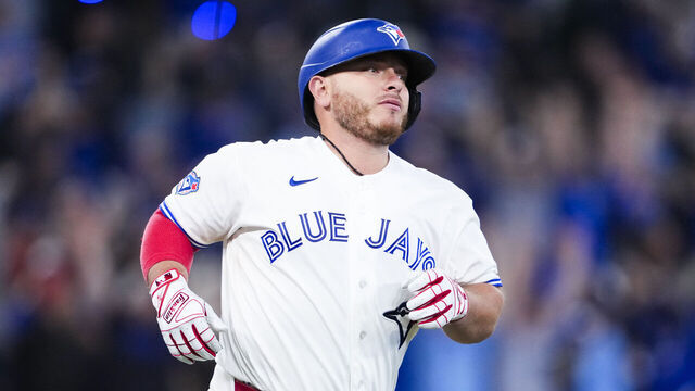 TORONTO, CANADA - MARCH 28: Alejandro Kirk #30 of the Toronto Blue Jays hits a solo home run against the Athletics during the ninth inning in their MLB game at Rogers Centre on March 28, 2026 in Toronto, Ontario, Canada.