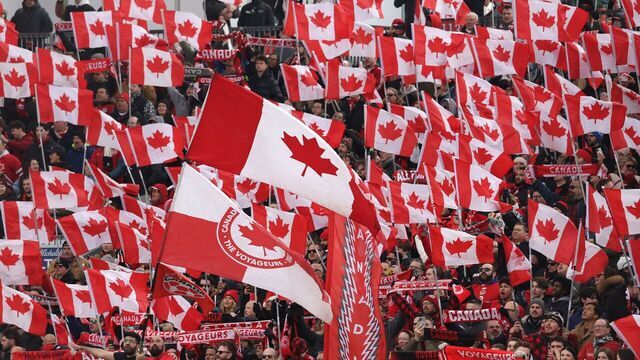 TORONTO, ON- MARCH 28 - Fans raise flags during anthems as Canada and Iceland draw 2-2- in a FIFA International Men's Friendly at BMO Field in Toronto. March 28, 2026. Steve Russell/Toronto Star (Steve Russell/Toronto Star via Getty Images)