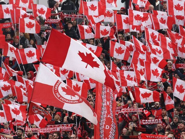 TORONTO, ON- MARCH 28 - Fans raise flags during anthems as Canada and Iceland draw 2-2- in a FIFA International Men's Friendly at BMO Field in Toronto. March 28, 2026. Steve Russell/Toronto Star (Steve Russell/Toronto Star via Getty Images)