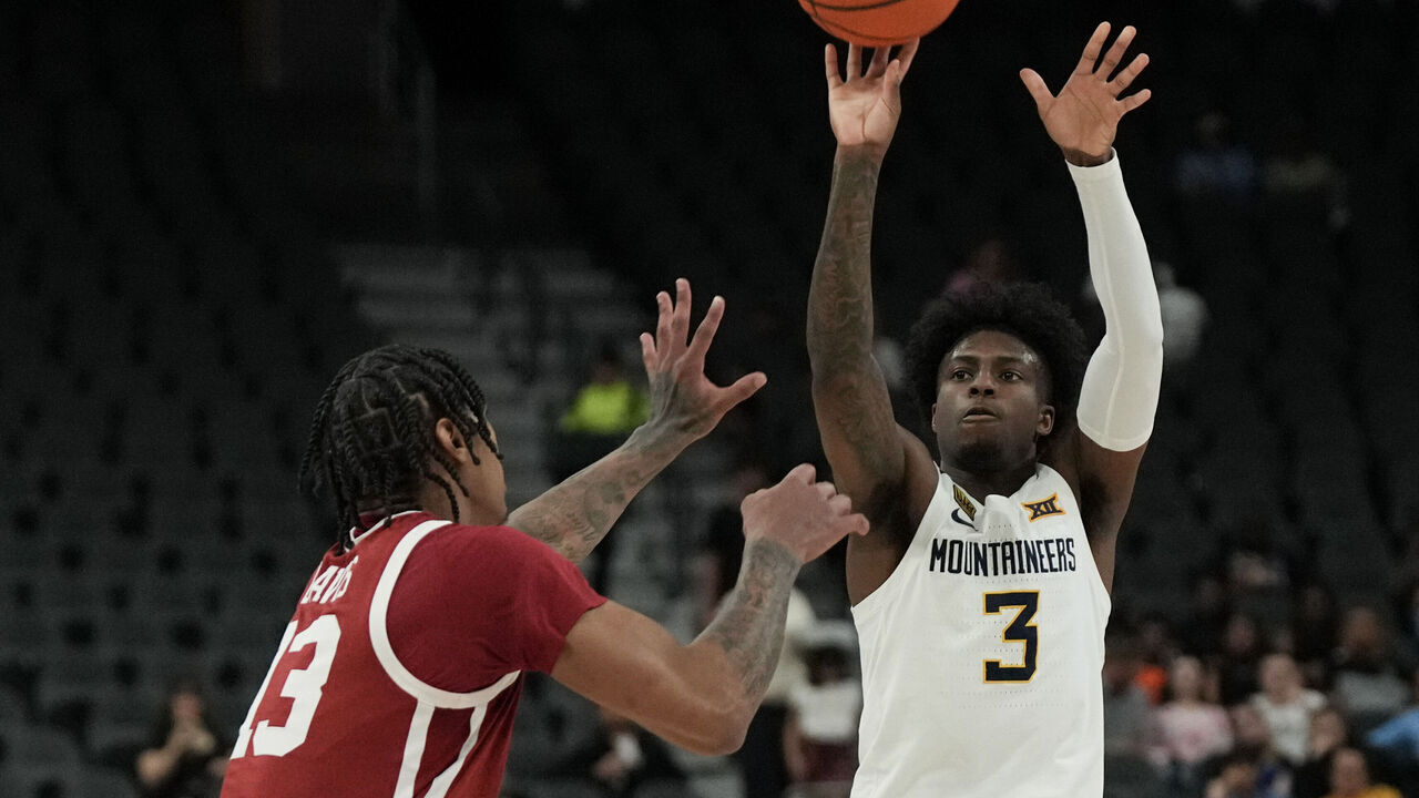 LAS VEGAS, NEVADA - APRIL 05: Honor Huff #3 of the West Virginia Mountaineers shoots against Tae Davis #13 of the Oklahoma Sooners in the first half of the championship game of the College Basketball Crown tournament at T-Mobile Arena on April 05, 2026 in Las Vegas, Nevada.