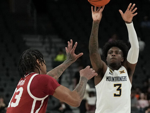 LAS VEGAS, NEVADA - APRIL 05: Honor Huff #3 of the West Virginia Mountaineers shoots against Tae Davis #13 of the Oklahoma Sooners in the first half of the championship game of the College Basketball Crown tournament at T-Mobile Arena on April 05, 2026 in Las Vegas, Nevada.