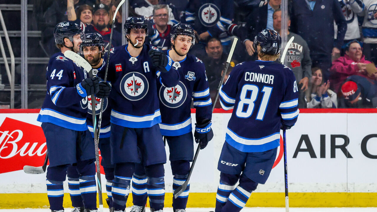WINNIPEG, CANADA - MARCH 26: Mark Scheifele #55, Josh Morrissey #44, Alex Iafallo #9, Elias Salomonsson #57, and Kyle Connor #81 of the Winnipeg Jets celebrate a first period goal against the Colorado Avalanche at Canada Life Centre on March 26, 2026 in Winnipeg, Manitoba, Canada.