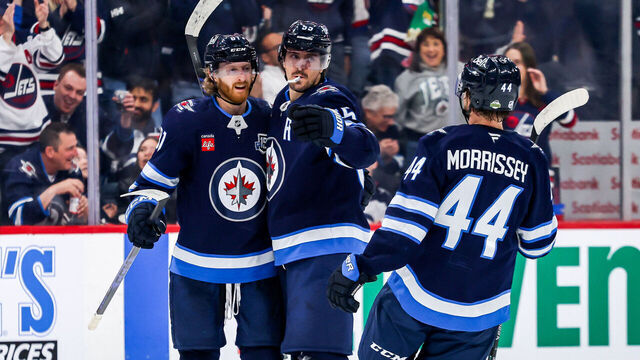 WINNIPEG, CANADA - APRIL 6: Kyle Connor #81, Mark Scheifele #55 and Josh Morrissey #44 of the Winnipeg Jets celebrate a second period goal against the Seattle Kraken at the Canada Life Centre on April 6, 2026 in Winnipeg, Manitoba, Canada.