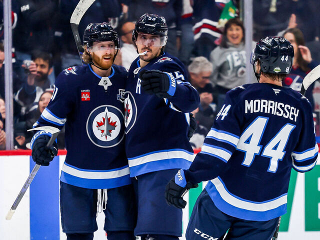 WINNIPEG, CANADA - APRIL 6: Kyle Connor #81, Mark Scheifele #55 and Josh Morrissey #44 of the Winnipeg Jets celebrate a second period goal against the Seattle Kraken at the Canada Life Centre on April 6, 2026 in Winnipeg, Manitoba, Canada.
