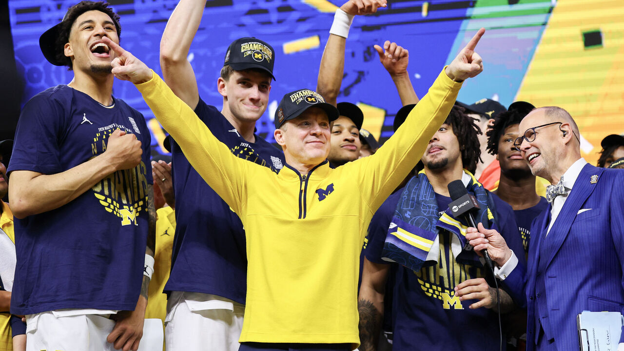 INDIANAPOLIS, INDIANA - APRIL 06: Head Coach Dusty May of the Michigan Wolverines celebrates with his team after defeating the UConn Huskies in the National Championship of the 2026 NCAA Men's Basketball Tournament at Lucas Oil Stadium on April 06, 2026 in Indianapolis, Indiana.