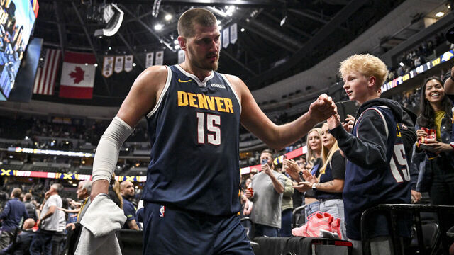 DENVER , CO - APRIL 6: Nikola Jokic (15) of the Denver Nuggets shakes hands with fans after the Nuggets' 137-132 overtime win over the Portland Trail Blazers at Ball Arena in Denver, Colorado on Monday, April 6, 2026.