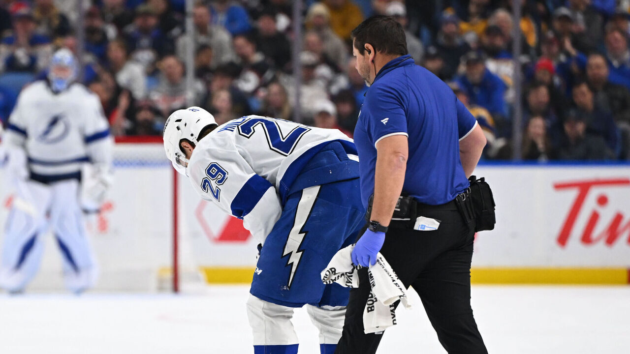 BUFFALO, NEW YORK - APRIL 6: Pontus Holmberg #29 of the Tampa Bay Lightning is helped off the ice by athletic training staff during the third period of an NHL game against the Buffalo Sabres at KeyBank Center on April 6, 2026 in Buffalo, New York. Buffalo won, 4-2.