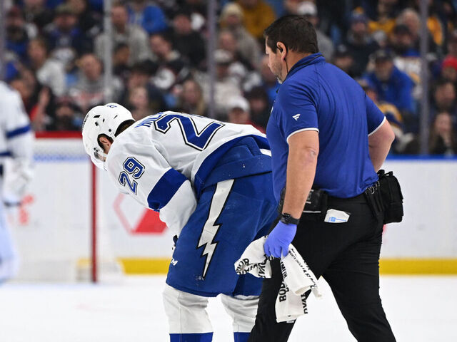 BUFFALO, NEW YORK - APRIL 6: Pontus Holmberg #29 of the Tampa Bay Lightning is helped off the ice by athletic training staff during the third period of an NHL game against the Buffalo Sabres at KeyBank Center on April 6, 2026 in Buffalo, New York. Buffalo won, 4-2.