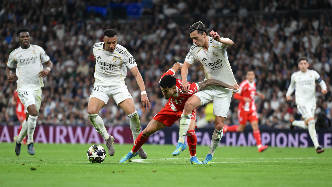MADRID, SPAIN - APRIL 07: Luis Diaz of FC Bayern Munich is tackled by Alvaro Carreras and Kylian Mbappe of Real Madrid during the UEFA Champions League 2025/26 Quarter-Final First Leg match between Real Madrid CF and FC Bayern München at Estadio Santiago Bernabeu on April 07, 2026 in Madrid, Spain.