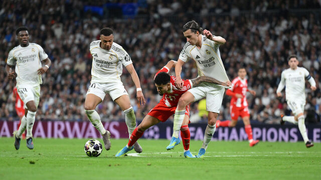 MADRID, SPAIN - APRIL 07: Luis Diaz of FC Bayern Munich is tackled by Alvaro Carreras and Kylian Mbappe of Real Madrid during the UEFA Champions League 2025/26 Quarter-Final First Leg match between Real Madrid CF and FC Bayern München at Estadio Santiago Bernabeu on April 07, 2026 in Madrid, Spain.