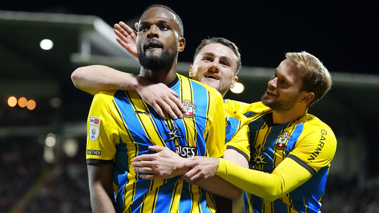 Southampton's Cyle Larin (left) celebrates with Taylor Harwood-Bellis and Leo Scienza after scoring his sides third goal during the Sky Bet Championship match at SToK Racecourse, Wrexham. Picture date: Tuesday April 7, 2026.