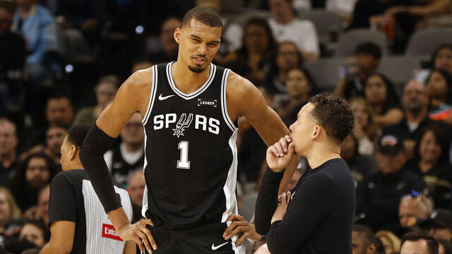 SAN ANTONIO, TX - APRIL 6: Victor Wembanyama #1 of the San Antonio Spurs talks with Mitch Johnson head coach of the San Antonio Spurs after his first injury against Andre Drummond #1 of the Philadelphia 76ers in the first half at Frost Bank Center on April 6, 2026 in San Antonio, Texas. NOTE TO USER: User expressly acknowledges and agrees that, by downloading and or using this photograph, User is consenting to terms and conditions of the Getty Images License Agreement.