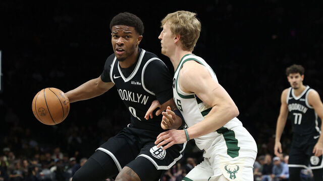 NEW YORK, NEW YORK - APRIL 07: E.J. Liddell #9 of the Brooklyn Nets dribbles the ball against AJ Green #20 of the Milwaukee Bucks during the first quarter at Barclays Center on April 07, 2026 in New York City.