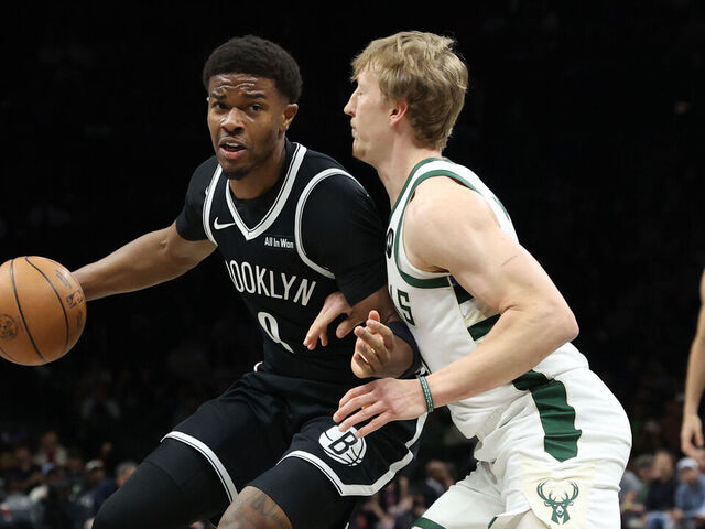NEW YORK, NEW YORK - APRIL 07: E.J. Liddell #9 of the Brooklyn Nets dribbles the ball against AJ Green #20 of the Milwaukee Bucks during the first quarter at Barclays Center on April 07, 2026 in New York City.