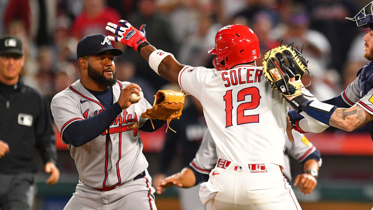 ANAHEIM, CA - APRIL 07: Atlanta Braves catcher Jonah Heim (20) tries to hold back Los Angeles Angels designated hitter Jorge Soler (12) as he swings a punch at Atlanta Braves pitcher Reynaldo Lopez (40) on the mound as home plate umpire Edwin Moscoso trails the play during the MLB game between the Atlanta Braves and the Los Angeles Angels on April 7, 2026 at Angel Stadium in Anaheim, CA.