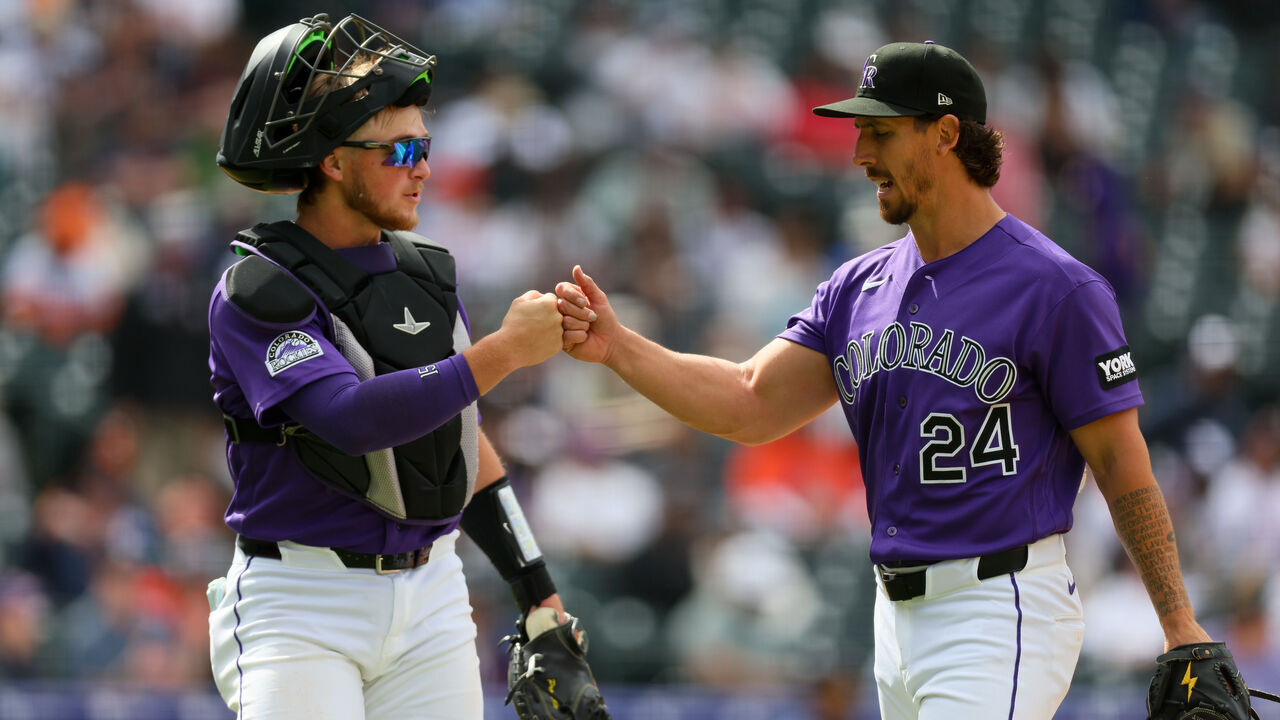 DENVER, CO - APRIL 8: Michael Lorenzen #24 of the Colorado Rockies fist-bumps teammate Hunter Goodman #15 as he walks off the field in the fifth inning against the Houston Astros at Coors Field on April 8, 2026 in Denver, Colorado.