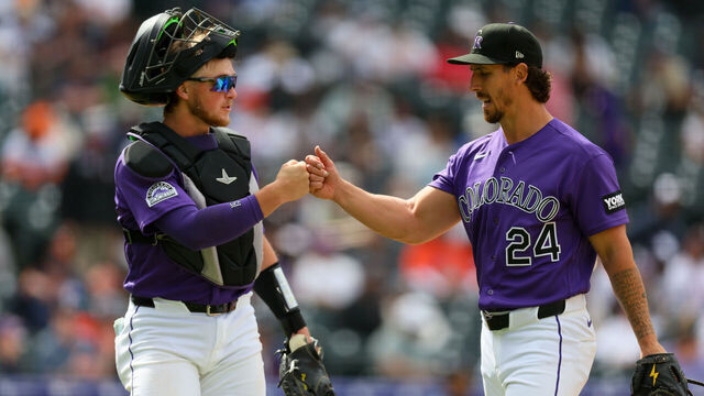 DENVER, CO - APRIL 8: Michael Lorenzen #24 of the Colorado Rockies fist-bumps teammate Hunter Goodman #15 as he walks off the field in the fifth inning against the Houston Astros at Coors Field on April 8, 2026 in Denver, Colorado.