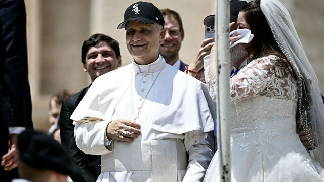 Pope Leo XIV (C) reacts wearing a Chicago White Sox baseball team cap as he meets newly wedded couples during the weekly general audience in St Peter's Square at the Vatican on June 11, 2025.