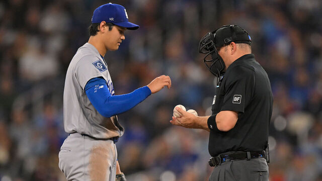 TORONTO, ON - APRIL 08: MLB umpire Dan Bellino offers Los Angeles Dodgers pitcher Shohei Ohtani (17) his pick of baseballs during the fifth inning of a MLB game between the Toronto Blue Jays and Los Angeles Dodgers on April 8, 2026, at Rogers Centre in Toronto, ON, Canada.