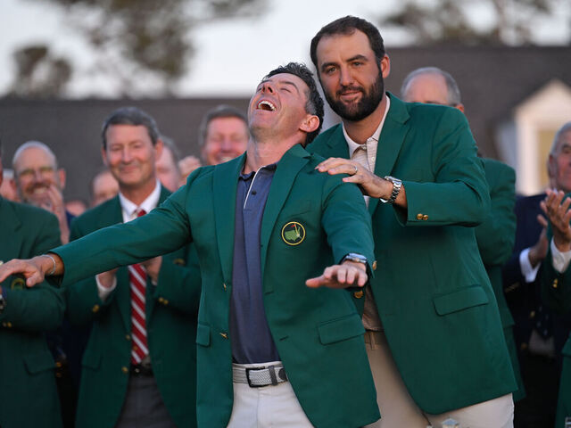 AUGUSTA, GEORGIA - APRIL 13: Rory McIlroy of Northern Ireland is awarded the green jacket by Scottie Scheffler during the green jacket ceremony, after final round of Masters Tournament at Augusta National Golf Club on April 13, 2025 in Augusta, Georgia.