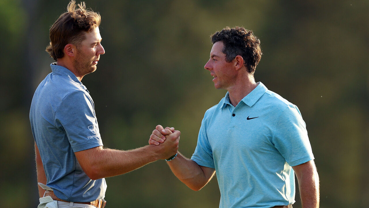 AUGUSTA, GEORGIA - APRIL 06: Sam Burns of the United States shakes hands with Rory McIlroy of Northern Ireland on the 18th green during the first round of the 2023 Masters Tournament at Augusta National Golf Club on April 06, 2023 in Augusta, Georgia.