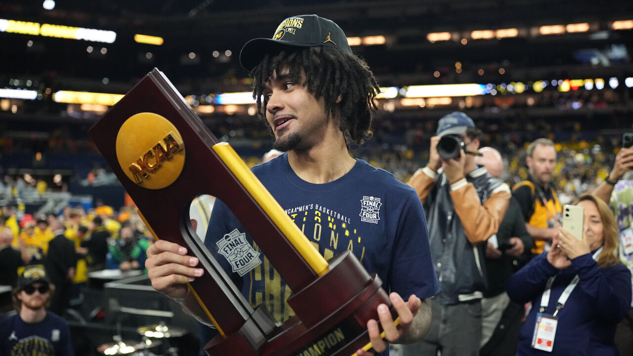 College Basketball: NCAA Finals: Michigan Elliot Cadeau (3) celebrates victory with the trophy following game vs UConn at Lucas Oil Stadium. Indianapolis, IN 4/6/2026 CREDIT: Erick W. Rasco