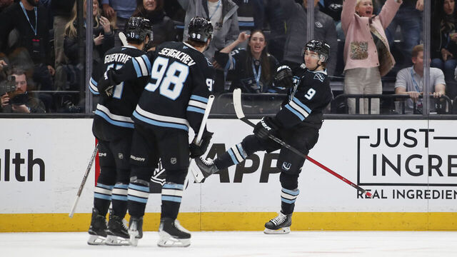 SALT LAKE CITY, UT - APRIL 9: Dylan Guenther #11 of the Utah Mammoth is congratulated by teamates Mikhail Sergachev #98 and Clayton Keller #9 after scoring against the Nashville Predators during the third period of their game at the Delta Center on April 9, 2026 in Salt Lake City, Utah.