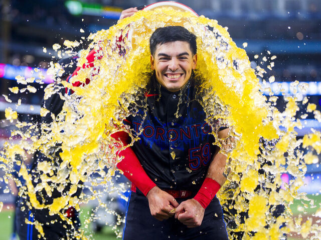 TORONTO, CANADA - APRIL 10: Brandon Valenzuela #59 of the Toronto Blue Jays gets doused in Underarmor sports drink following his team's win against the Minnesota Twins in their MLB game at the Rogers Centre on April 10, 2026 in Toronto, Ontario, Canada.