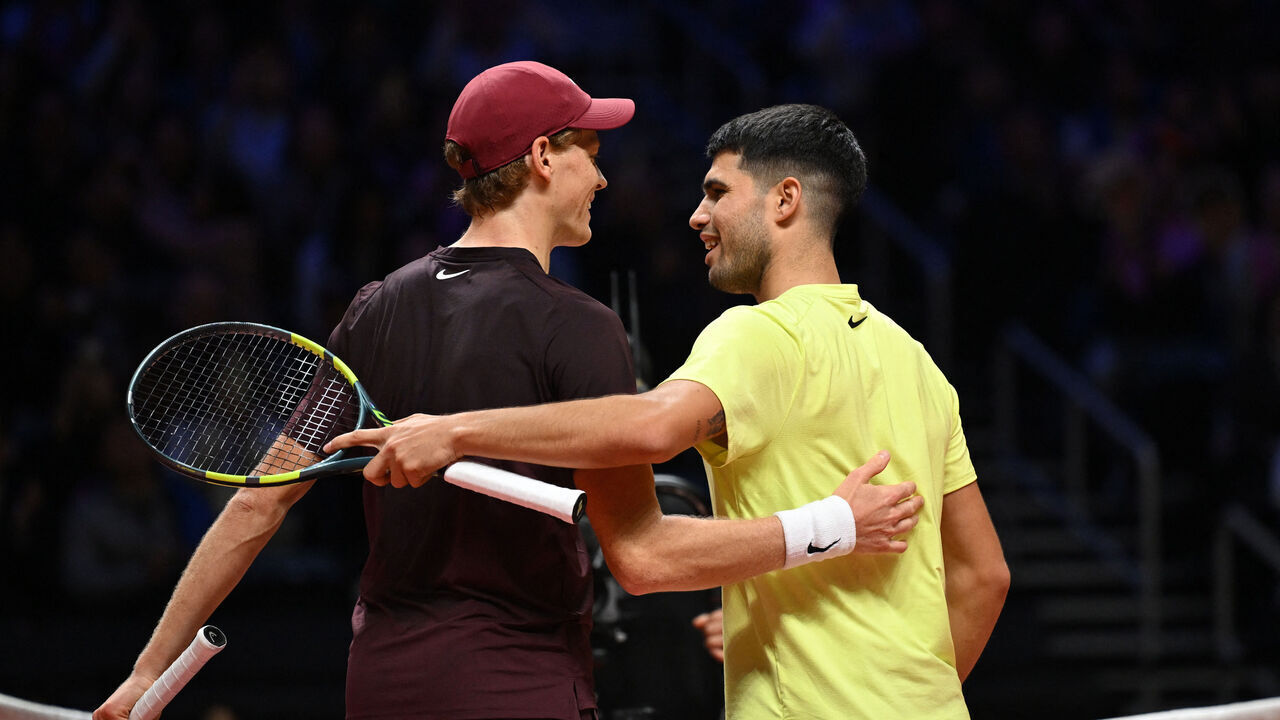 Spain's Carlos Alcaraz (R) shakes hands with Italy's Jannik Sinner (L) after their exhibition tennis match at Inspire Arena in Incheon on January 10, 2026.