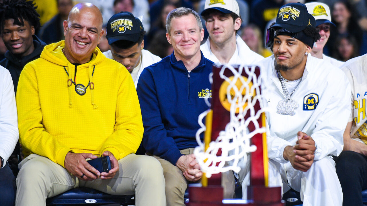 ANN ARBOR, MICHIGAN - APRIL 11: (L-R) University of Michigan Athletic Director Warde Manuel, Head Basketball Coach Dusty May, and Yaxel Lendeborg #23 of the Michigan Wolverines look on during the Michigan Men's Basketball National Championship celebration at Crisler Arena on April 11, 2026 in Ann Arbor, Michigan.