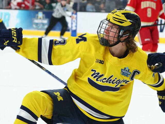 LAS VEGAS, NEVADA - APRIL 9: T.J. Hughes #13 and Adam Valentini #92 of the Michigan Wolverines celebrate after a goal against the Denver Pioneers during the Division I Men's Ice Hockey Championship held at T-Mobile Arena on April 9, 2026 in Las Vegas, Nevada.