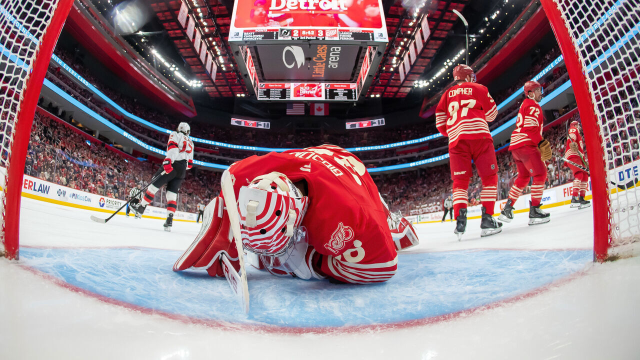 DETROIT, MICHIGAN - APRIL 11: Cody Glass #12 of the New Jersey Devils scores a goal to tie the game on John Gibson #36 of the Detroit Red Wings during the third period at Little Caesars Arena on April 11, 2026 in Detroit, Michigan. New Jersey defeated Detroit 5-3.
