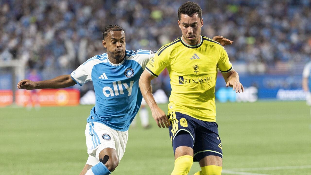 CHARLOTTE, NORTH CAROLINA - APRIL 11: Daniel Lovitz #2 of the Nashville SC controls the ball during a challenge by Kerwin Vargas #18 of the Charlotte FC during a game between Charlotte FC and Nashville SC at Bank of America Stadium on April 11, 2026 in Charlotte, North Carolina.