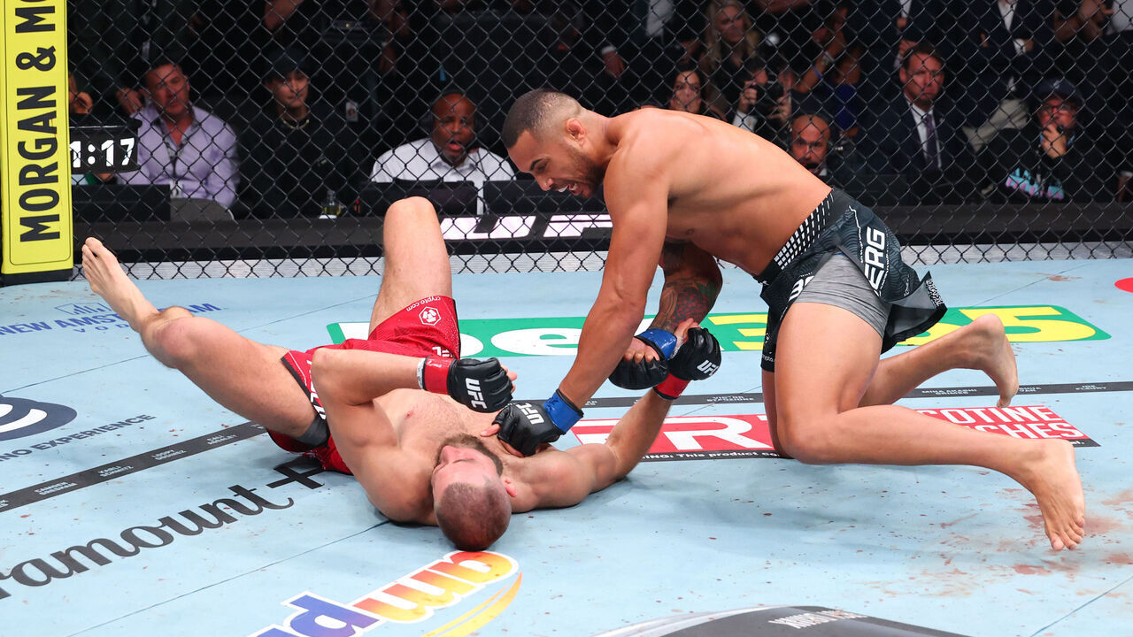 MIAMI, FLORIDA - APRIL 11: Carlos Ulberg of New Zealand punches Jiri Prochazka of the Czech Republic in the UFC light heavyweight championship fight during the UFC 327 event at Kaseya Center on April 11, 2026 in Miami, Florida.