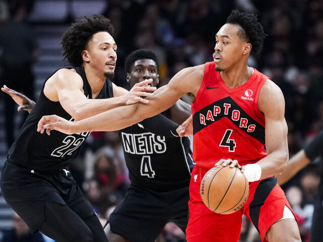 TORONTO, CANADA - APRIL 12: Scottie Barnes #4 of the Toronto Raptors dribbles against Jalen Wilson #22 of the Brooklyn Nets during the first half at Scotiabank Arena on April 12, 2026 in Toronto, Ontario, Canada. NOTE TO USER: User expressly acknowledges and agrees that, by downloading and/or using this Photograph, user is consenting to the terms and conditions of the Getty Images License Agreement.