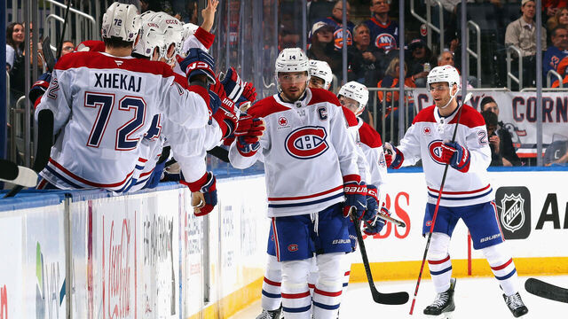 ELMONT, NEW YORK - APRIL 12: Nick Suzuki #14 of the Montréal Canadiens celebrates his goal and 100th point of the season at 15:46 of the second period against the New York Islanders at UBS Arena on April 12, 2026 in Elmont, New York.