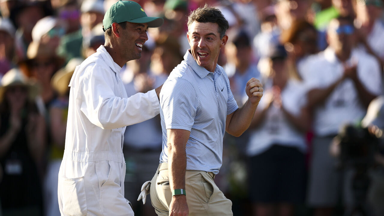 AUGUSTA, GEORGIA - APRIL 12: Rory McIlroy of Northern Ireland and his caddie Harry Diamond celebrate winning the final round of the 2026 Masters Tournament on the 18th green at Augusta National Golf Club on April 12, 2026 in Augusta, Georgia.