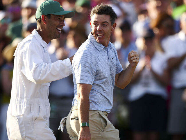 AUGUSTA, GEORGIA - APRIL 12: Rory McIlroy of Northern Ireland and his caddie Harry Diamond celebrate winning the final round of the 2026 Masters Tournament on the 18th green at Augusta National Golf Club on April 12, 2026 in Augusta, Georgia.