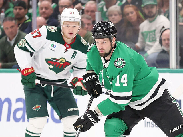 DALLAS, TEXAS - APRIL 09: Jamie Benn #14 of the Dallas Stars advances the puck under pressure from Kirill Kaprizov #97 of the Minnesota Wild at American Airlines Center on April 09, 2026 in Dallas, Texas.