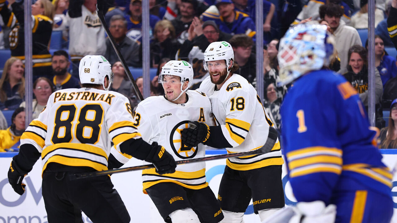 BUFFALO, NEW YORK - MARCH 25: Pavel Zacha #18 of the Boston Bruins celebrates his overtime game-winning goal against Ukko-Pekka Luukkonen #1 of the Buffalo Sabres with Charlie McAvoy #73 and David Pastrnak #88 during an NHL game on March 25, 2026 at KeyBank Center in Buffalo, New York.
