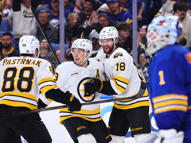 BUFFALO, NEW YORK - MARCH 25: Pavel Zacha #18 of the Boston Bruins celebrates his overtime game-winning goal against Ukko-Pekka Luukkonen #1 of the Buffalo Sabres with Charlie McAvoy #73 and David Pastrnak #88 during an NHL game on March 25, 2026 at KeyBank Center in Buffalo, New York.