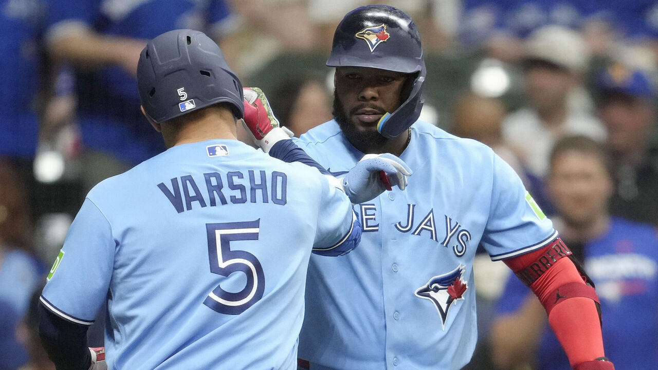 MILWAUKEE, WISCONSIN - APRIL 14: Daulton Varsho #5 of the Toronto Blue Jays celebrates with Vladimir Guerrero Jr. #27 after hitting a solo home run against the Milwaukee Brewers during the sixth inning at American Family Field on April 14, 2026 in Milwaukee, Wisconsin.